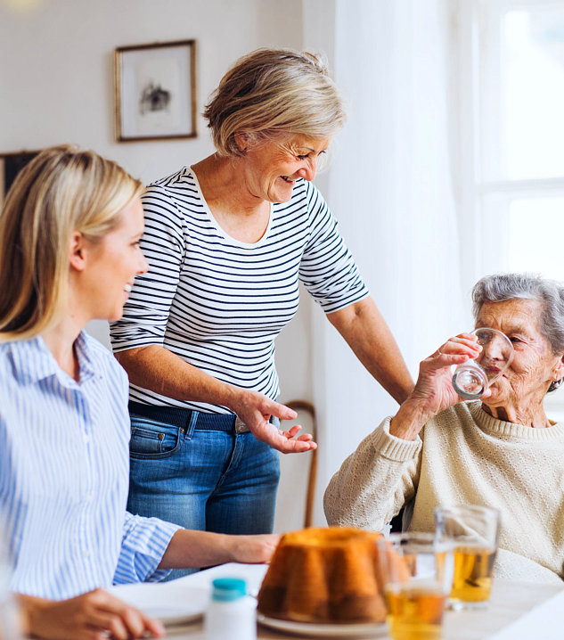 happy two senior women with female caregiver