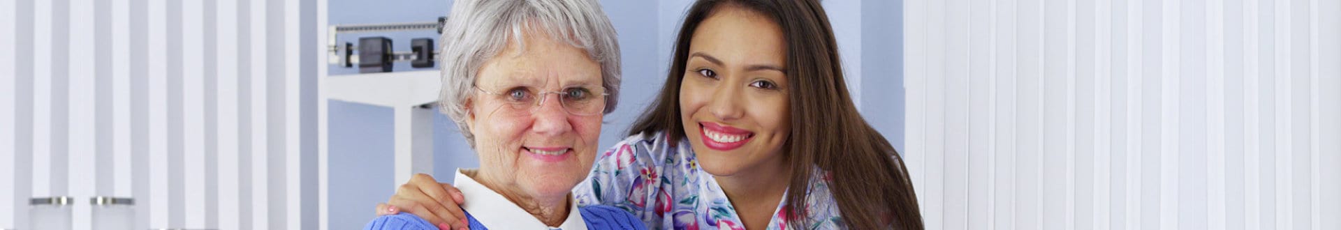 senior woman and caregiver smiling