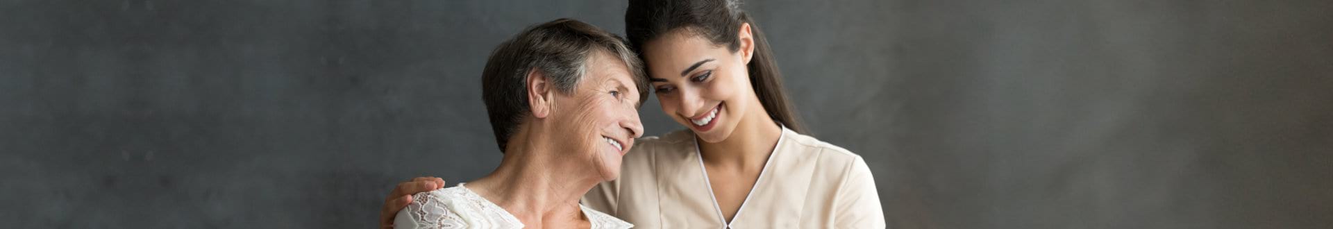 female caregiver with senior woman smiling