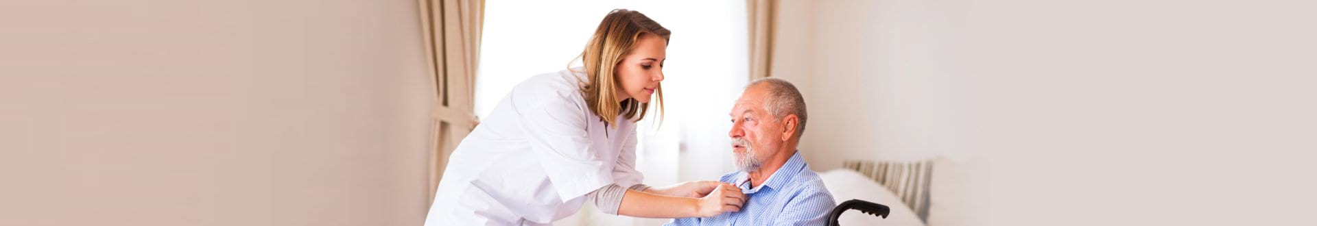 caregiver assisting senior man on wheelchair