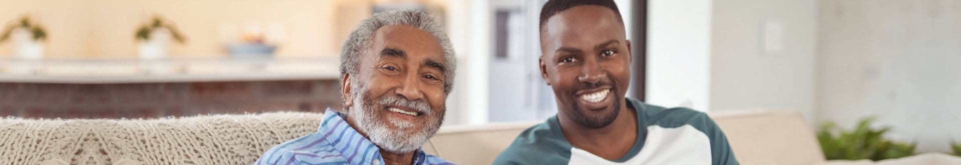 senior man and male caregiver smiling